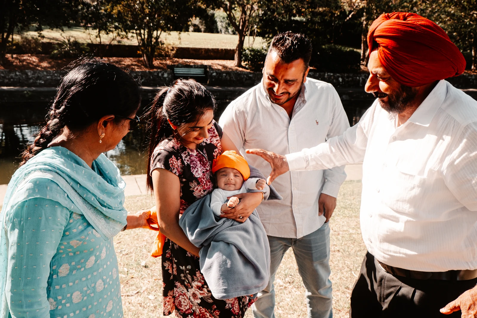 Indian family wrapping baby's turban